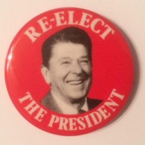 Re elect the President Reagan on red background
